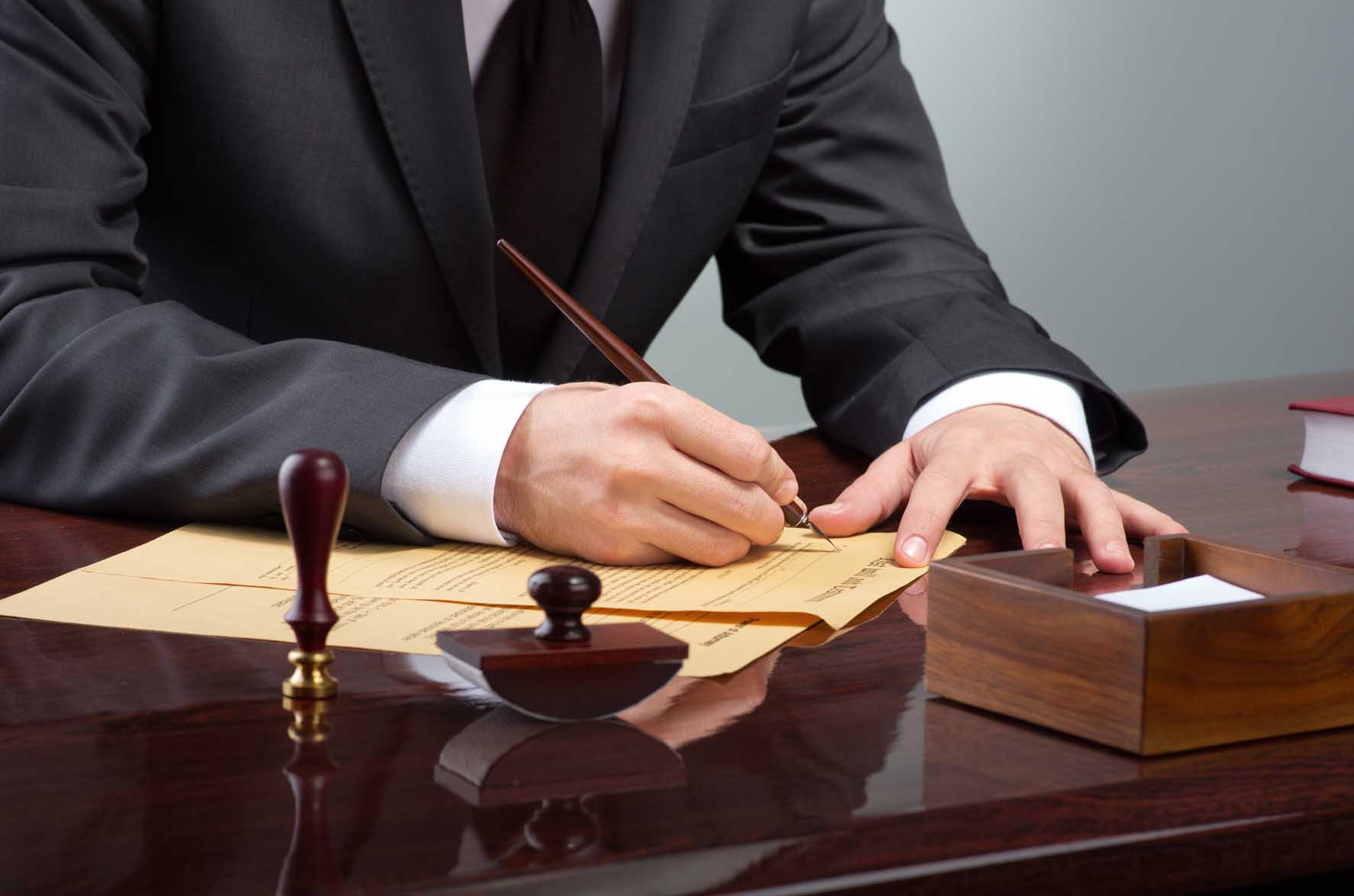 Businessman writing testament at notary public office